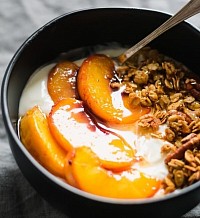 Yogurt bowl with granola and sessional fruit